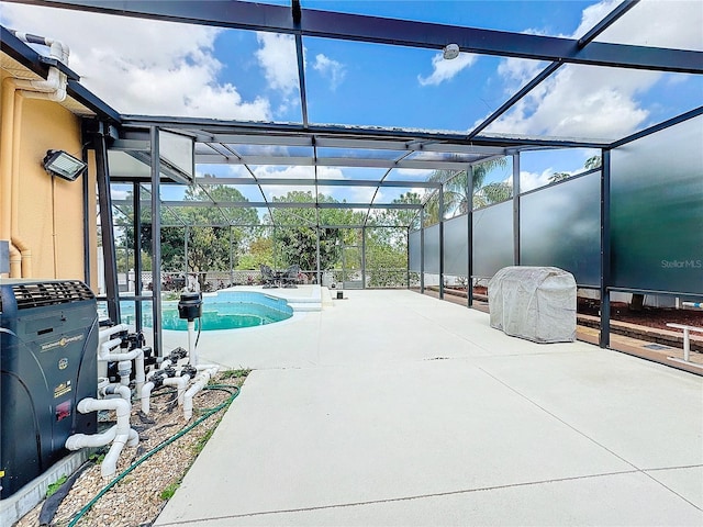 view of swimming pool featuring a patio area and glass enclosure