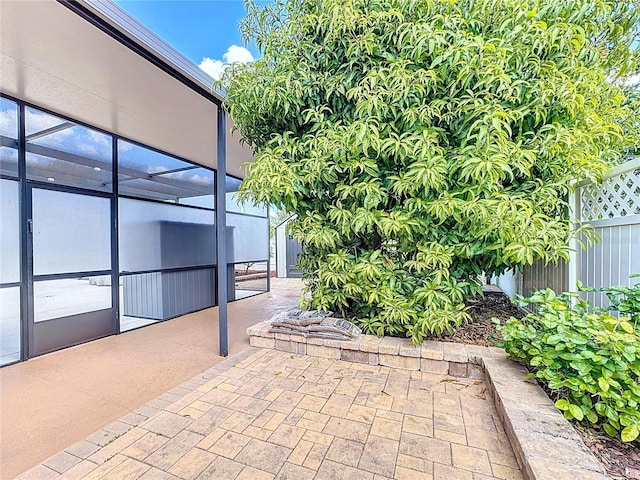 view of patio / terrace featuring glass enclosure