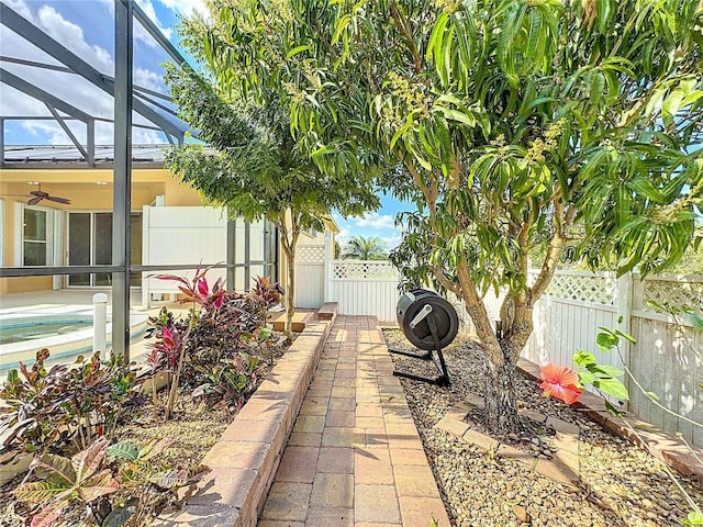 view of patio / terrace featuring a swimming pool and glass enclosure