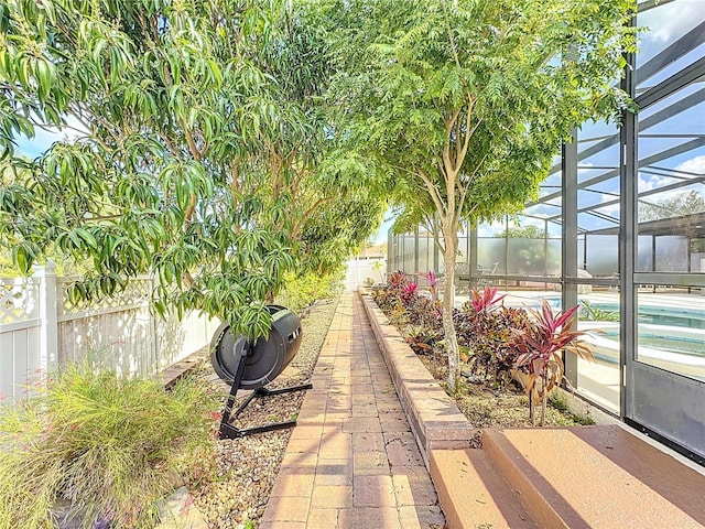 view of patio / terrace with a fenced in pool and glass enclosure