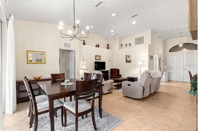 dining space with high vaulted ceiling, ceiling fan with notable chandelier, visible vents, and light tile patterned flooring