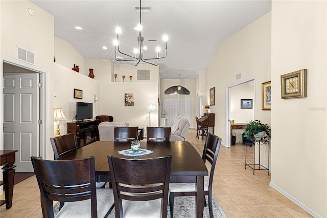 dining room with light tile patterned floors, visible vents, and a notable chandelier