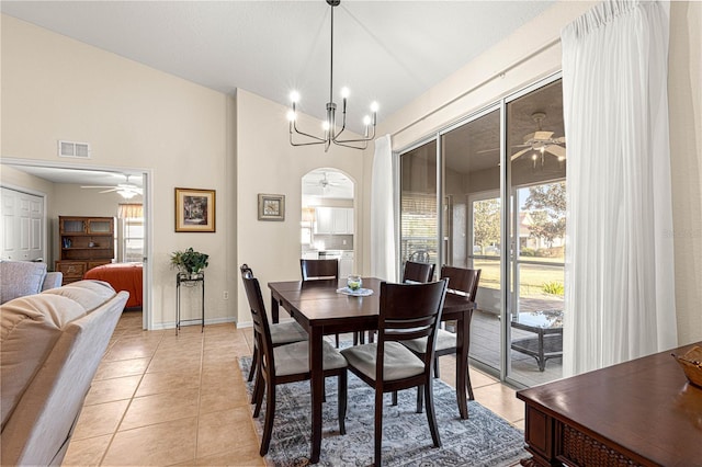 dining room with plenty of natural light, visible vents, ceiling fan with notable chandelier, and light tile patterned flooring