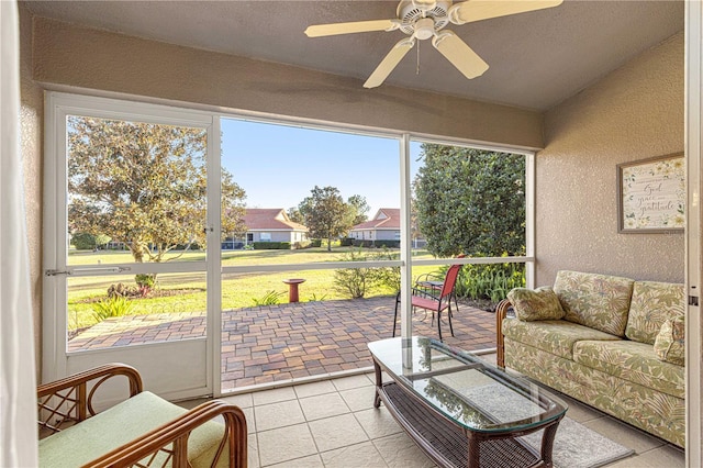 sunroom with a ceiling fan