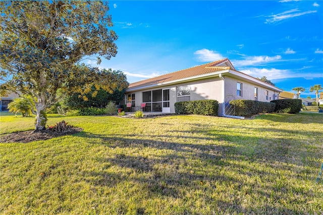 view of side of home with a lawn and stucco siding