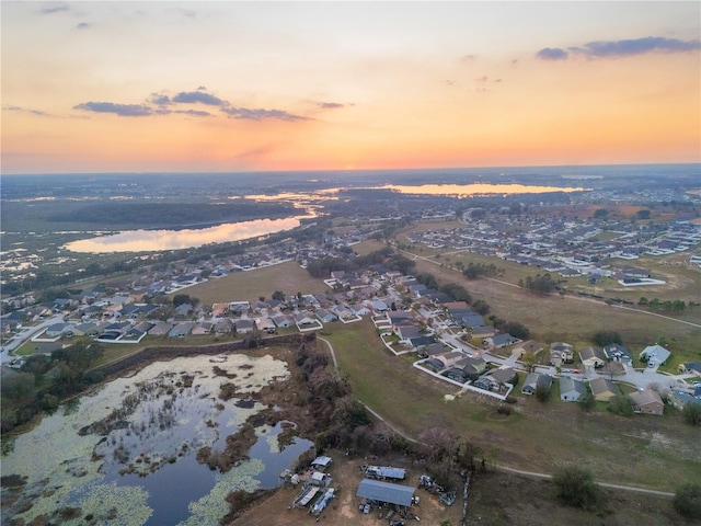 aerial view at dusk with a water view