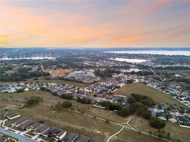 aerial view at dusk with a water view