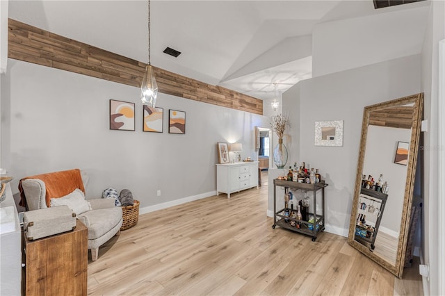 living area with lofted ceiling and light hardwood / wood-style floors