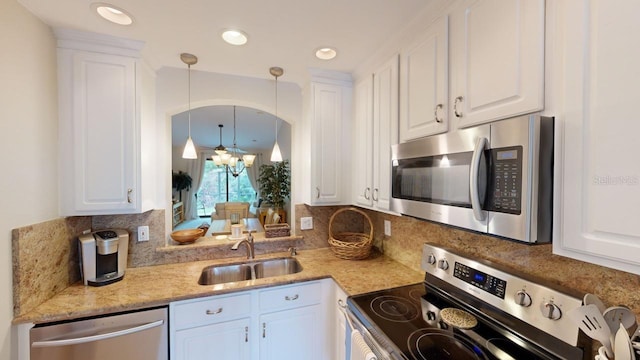 kitchen with stainless steel appliances, white cabinetry, and sink