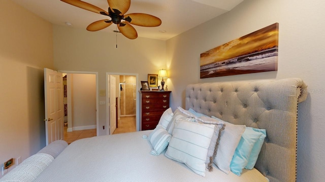 bedroom featuring ceiling fan, ensuite bathroom, and light tile patterned floors