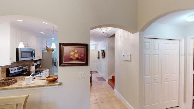 hallway featuring light tile patterned floors