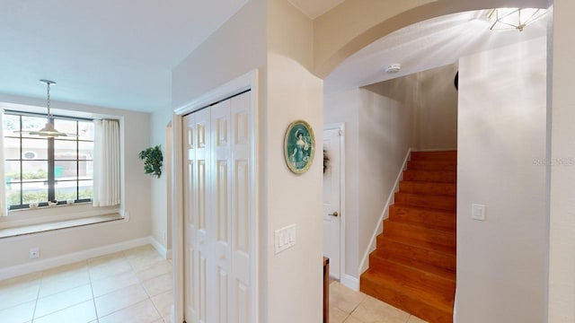 staircase featuring tile patterned flooring