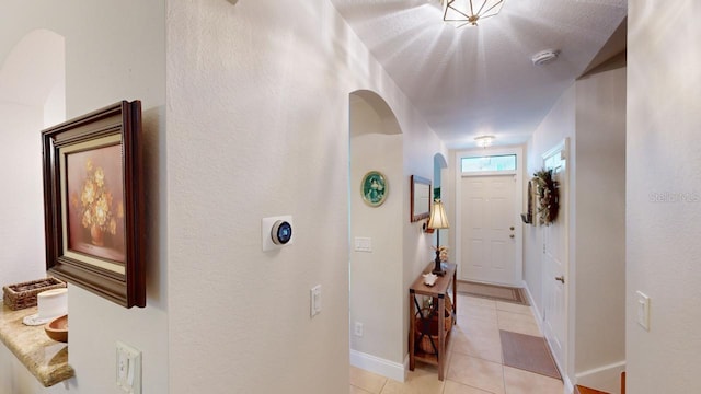 hall with light tile patterned floors