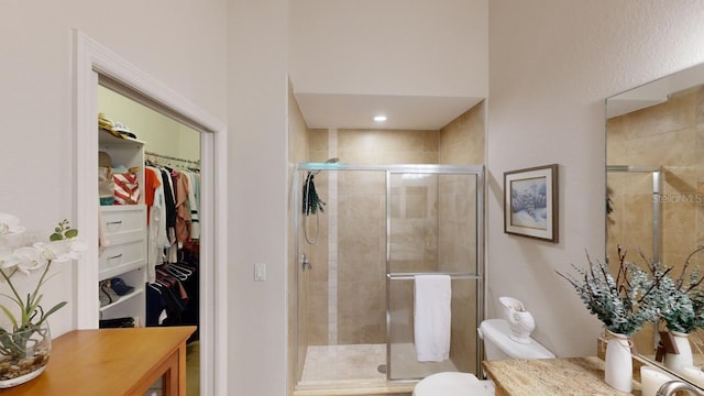 bathroom with toilet and a shower with shower door