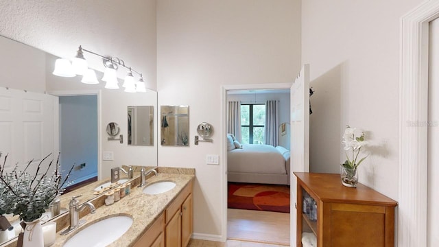 bathroom with vanity and a towering ceiling