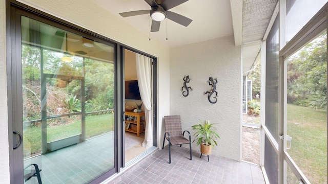 sunroom featuring a healthy amount of sunlight and ceiling fan