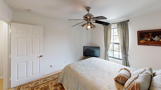 bedroom featuring light carpet and ceiling fan