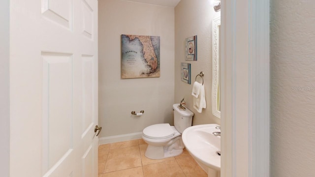 bathroom with sink, tile patterned floors, and toilet