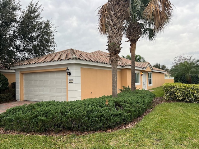 view of side of property featuring a garage and a yard