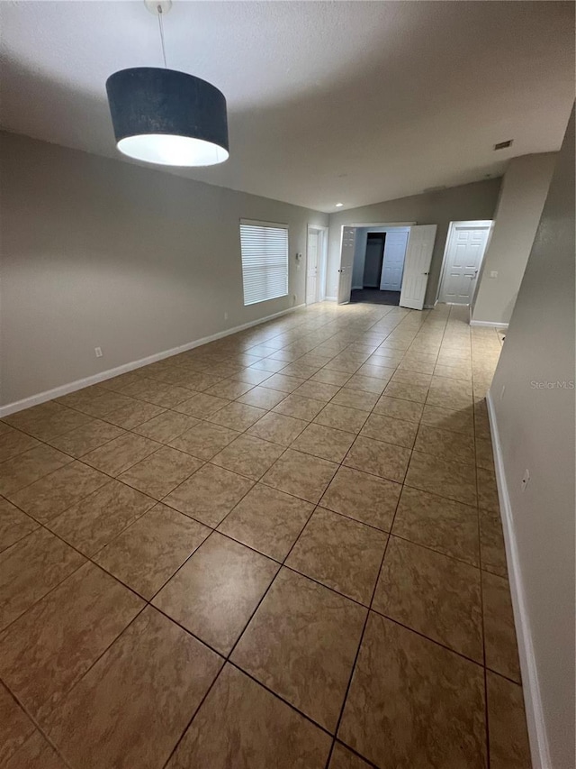 unfurnished room with tile patterned floors