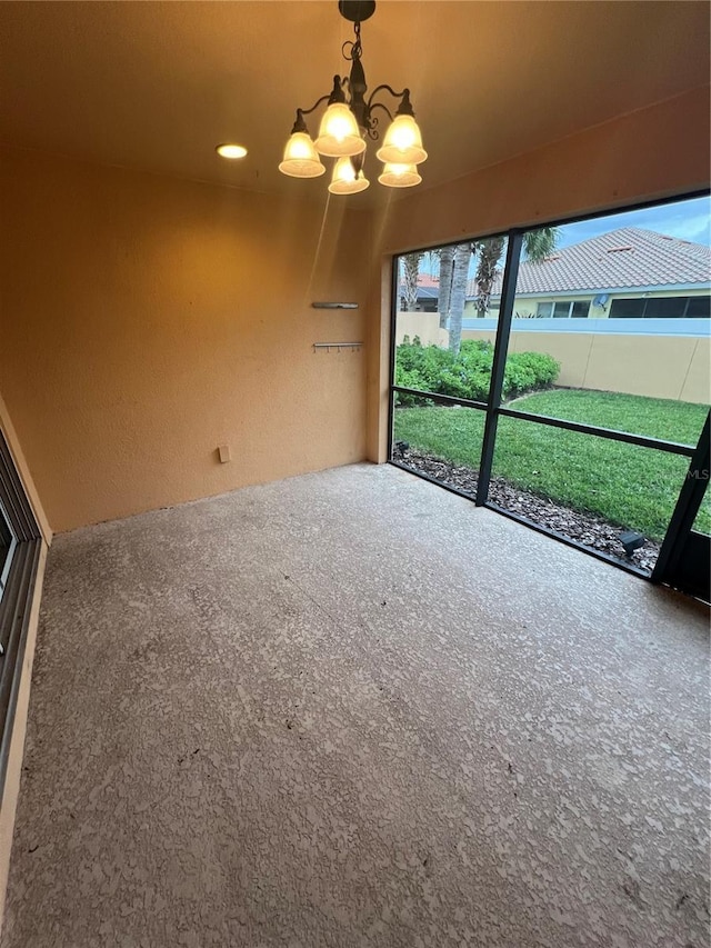 interior space with carpet floors and a notable chandelier