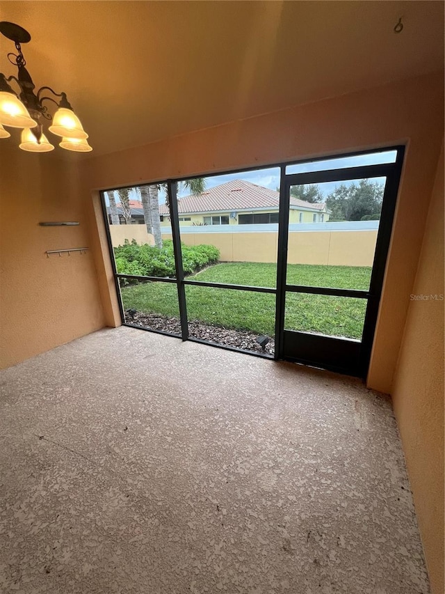 unfurnished sunroom with a notable chandelier