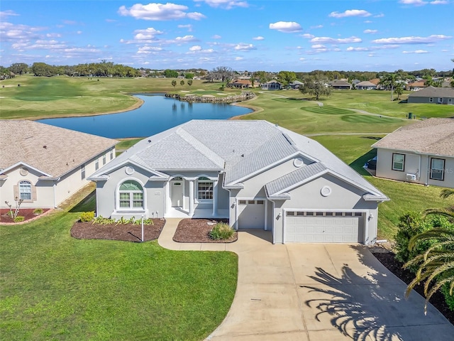 view of front of home with a front lawn, view of golf course, a water view, concrete driveway, and a garage