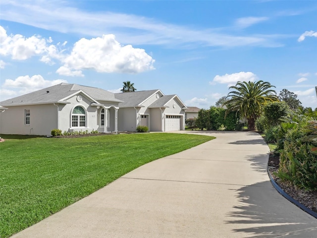 view of front facade featuring stucco siding, an attached garage, concrete driveway, and a front yard