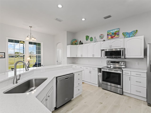 kitchen with light countertops, visible vents, appliances with stainless steel finishes, and a sink