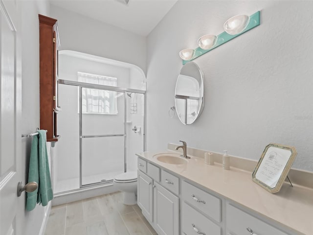 full bath featuring a shower stall, toilet, and vanity