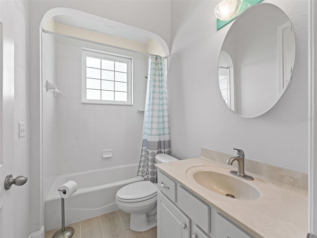 bathroom featuring shower / bath combo with shower curtain, toilet, and vanity