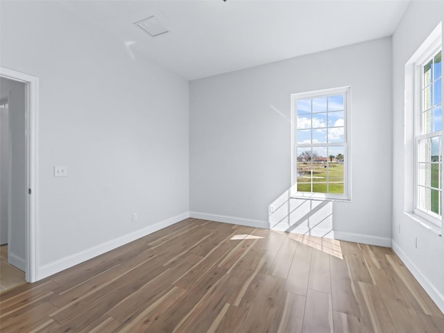 unfurnished room with baseboards and wood finished floors