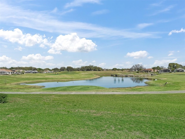 exterior space featuring a lawn and a water view