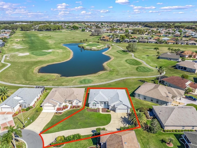 drone / aerial view with a residential view, golf course view, and a water view