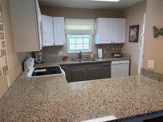 1152 Villa Ln Unit 104, Apopka, FL 32712 - kitchen featuring white appliances, kitchen peninsula, sink, and white cabinets