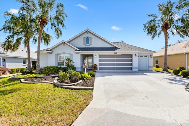 ranch-style home with a garage and a front yard