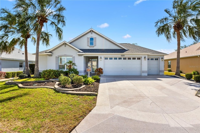 view of front of home with a garage and a front lawn