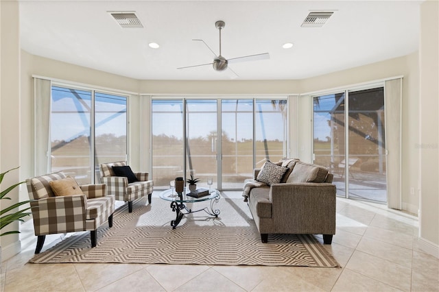 living room featuring a wealth of natural light, ceiling fan, and light tile patterned floors