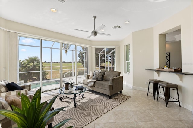 living room with light tile patterned floors and ceiling fan