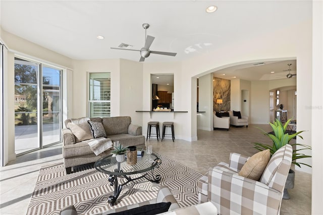 tiled living room featuring ceiling fan