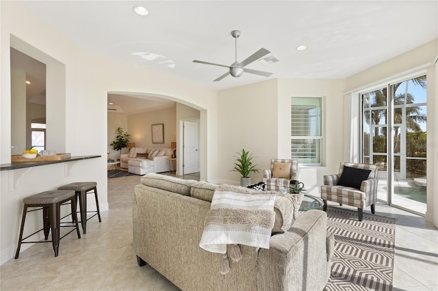 living room with ceiling fan and light tile patterned floors