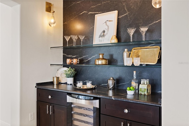 bar with wine cooler, tasteful backsplash, and dark brown cabinetry