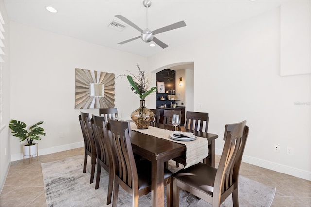 tiled dining space featuring ceiling fan