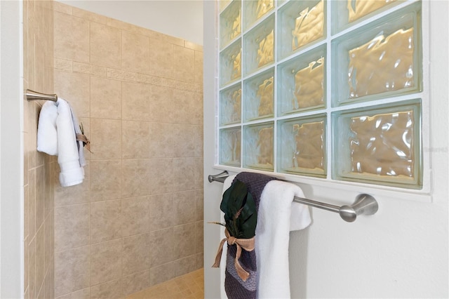 bathroom with a tile shower