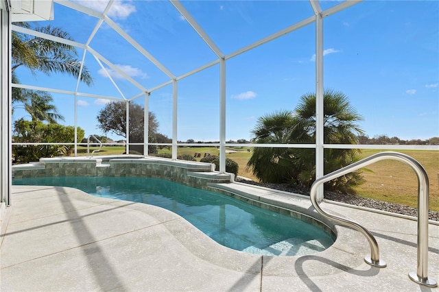 view of pool with a patio and glass enclosure