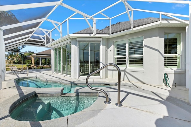 view of pool with a patio, an in ground hot tub, and glass enclosure