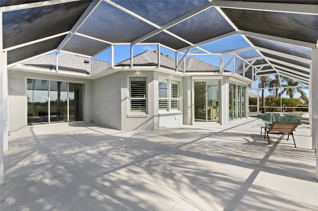 rear view of house with a patio and a lanai