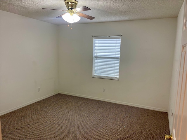 unfurnished room featuring a textured ceiling, baseboards, a ceiling fan, and carpet