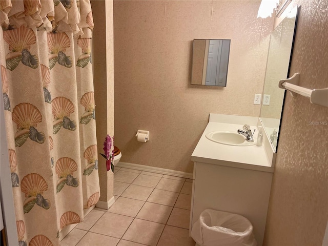 full bathroom with vanity, baseboards, curtained shower, tile patterned flooring, and toilet