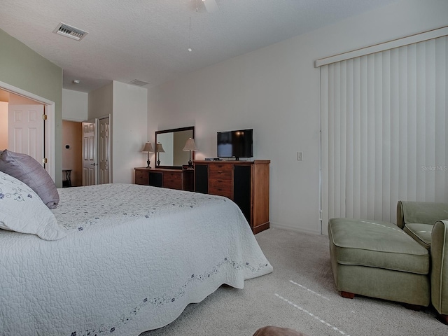 carpeted bedroom featuring a textured ceiling